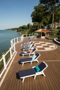 Spacious custom deck with lounge chairs overlooking the water, built by DreamDecks in Northeast Ohio.