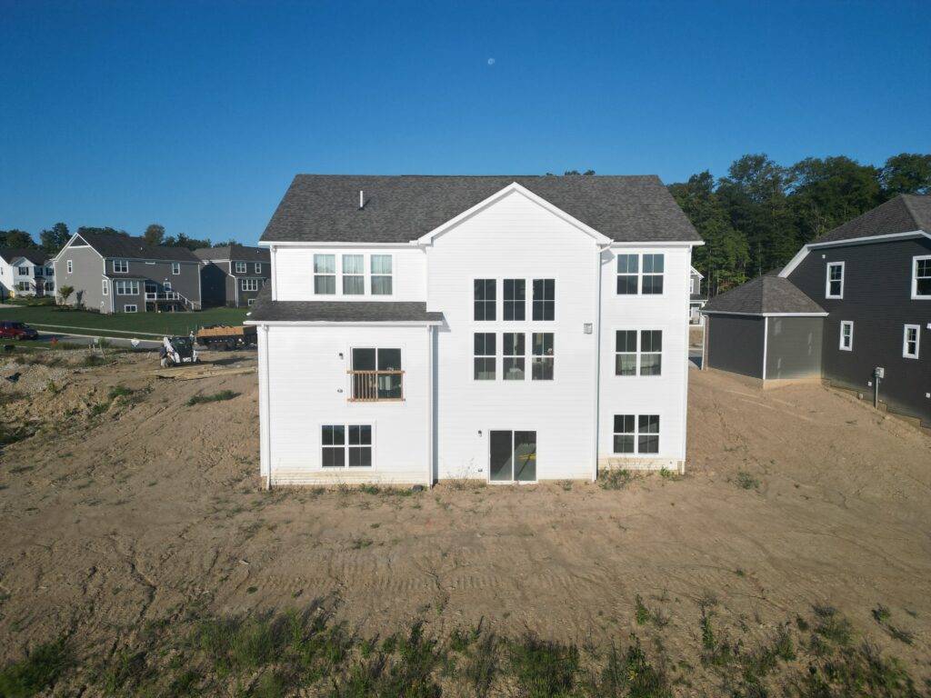 The new home with a bare backyard before the deck build
