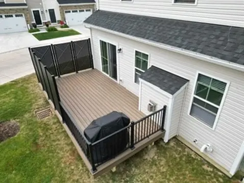 Elevated deck with stairs and white railing attached to house by DreamDecks