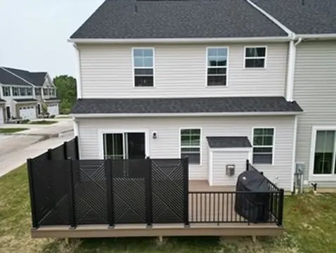 Two-story home with large deck and stairs by DreamDecks