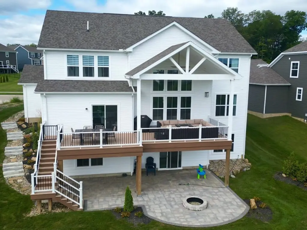 Covered Patios & Roof Structures in Northeast Ohio 1 DreamDecks designs and builds architectural-grade outdoor living spaces across Northeast Ohio. From modern decks to full backyard sanctuaries, each project reflects craftsmanship, precision, and timeless luxury. Call 330-907-3040 or visit buildyourDreamDeck.com DreamDecks | Premier Deck Builder & Outdoor Architecture Covered patio with a stylish roof structure featuring wood beams and comfortable seating in a Northeast Ohio backyard