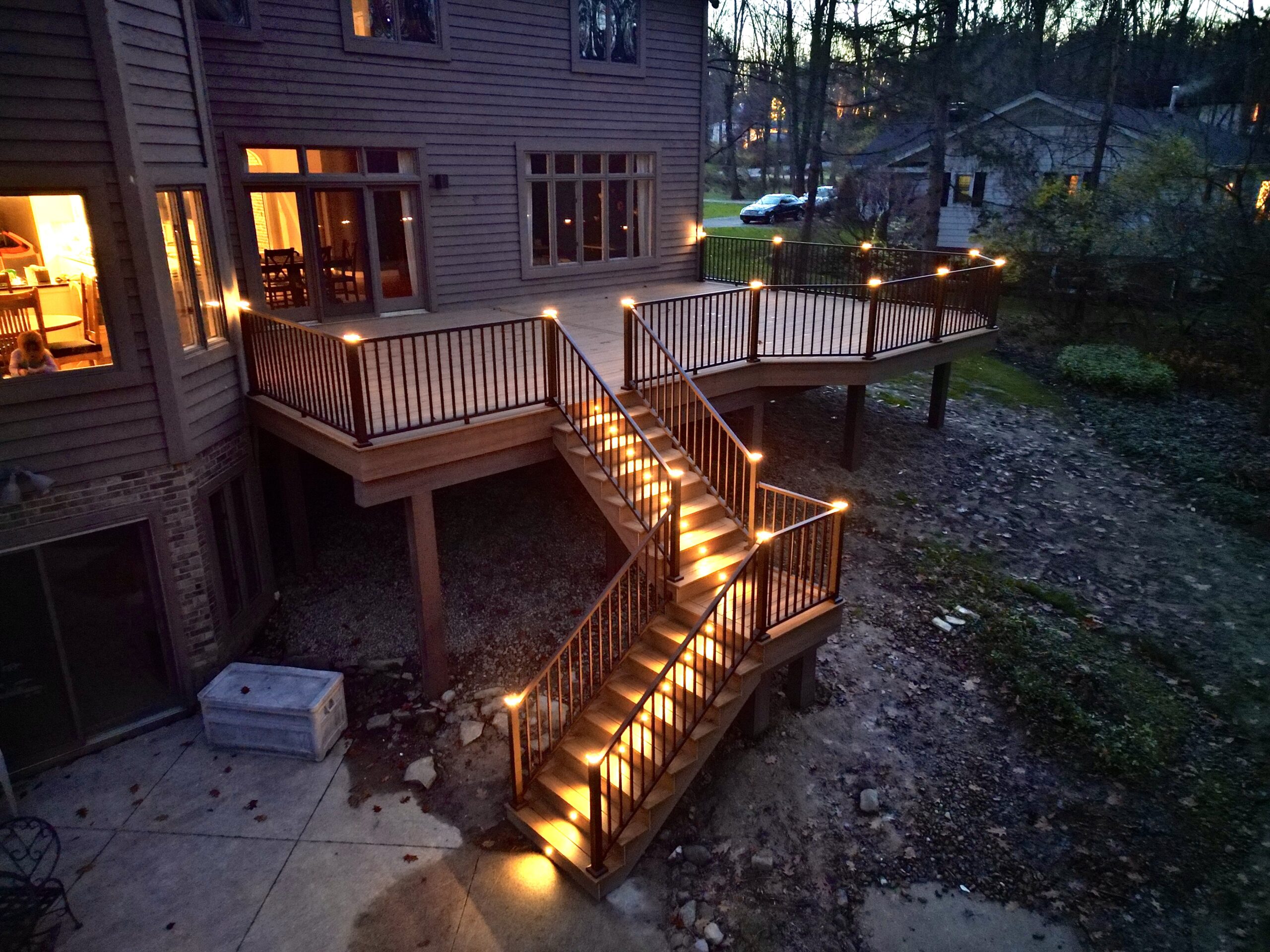 Spacious multi-level wooden deck with outdoor seating and fire pit by DreamDecks in Northeast Ohio