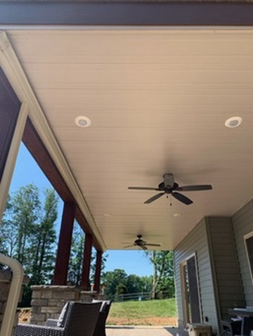 Covered deck with a finished ceiling and fan by DreamDecks
