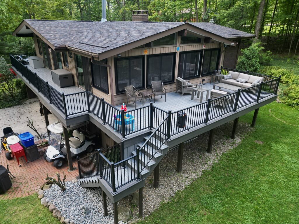 Aerial view of a custom wooden deck with outdoor seating and lighting in Northeast Ohio