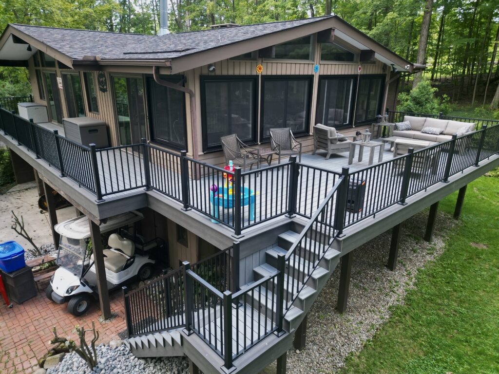 Spacious multi-level wooden deck with outdoor furniture and pergola in Northeast Ohio backyard