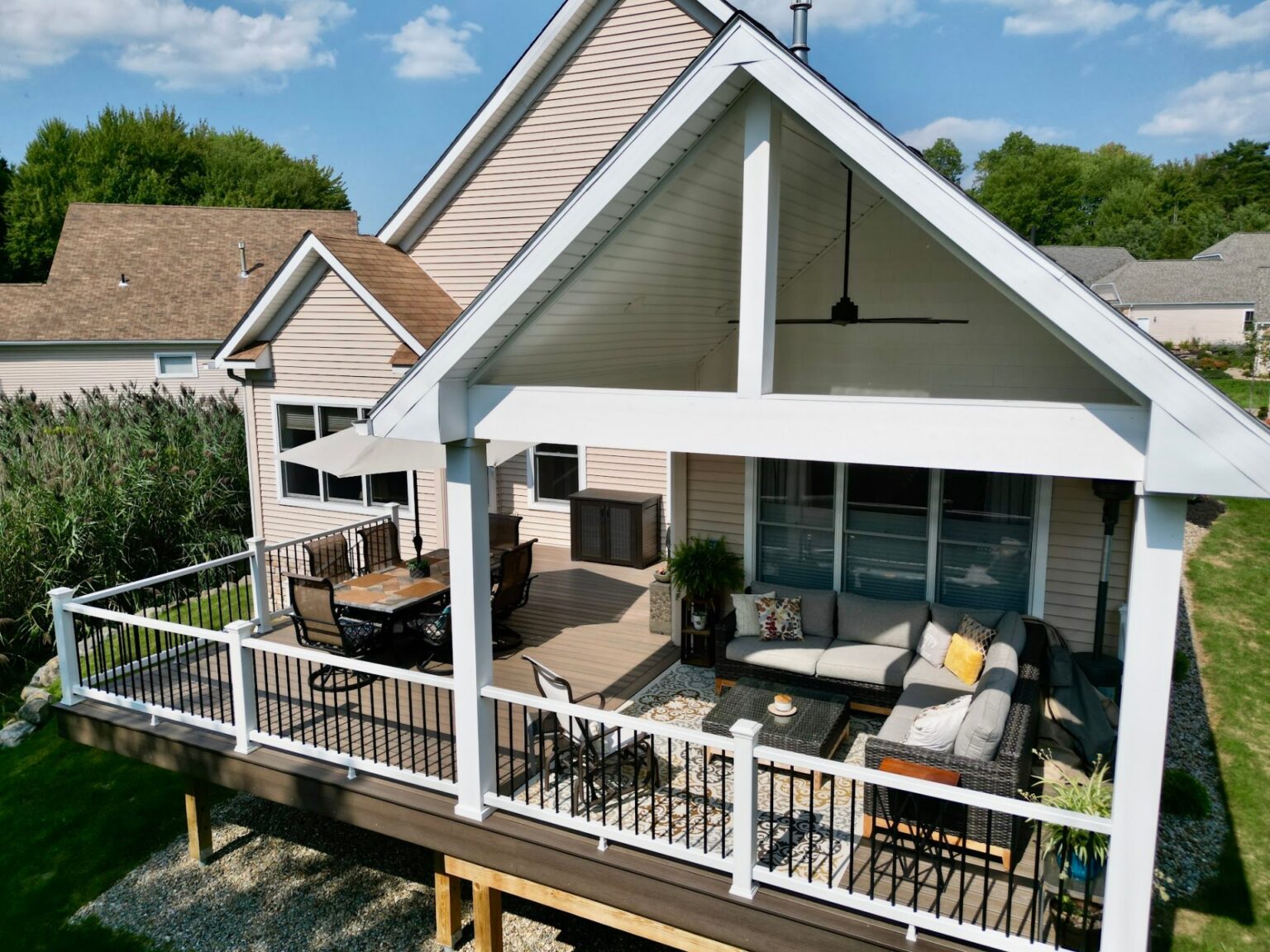 Covered composite deck with outdoor furniture built by DreamDecks in Northeast Ohio