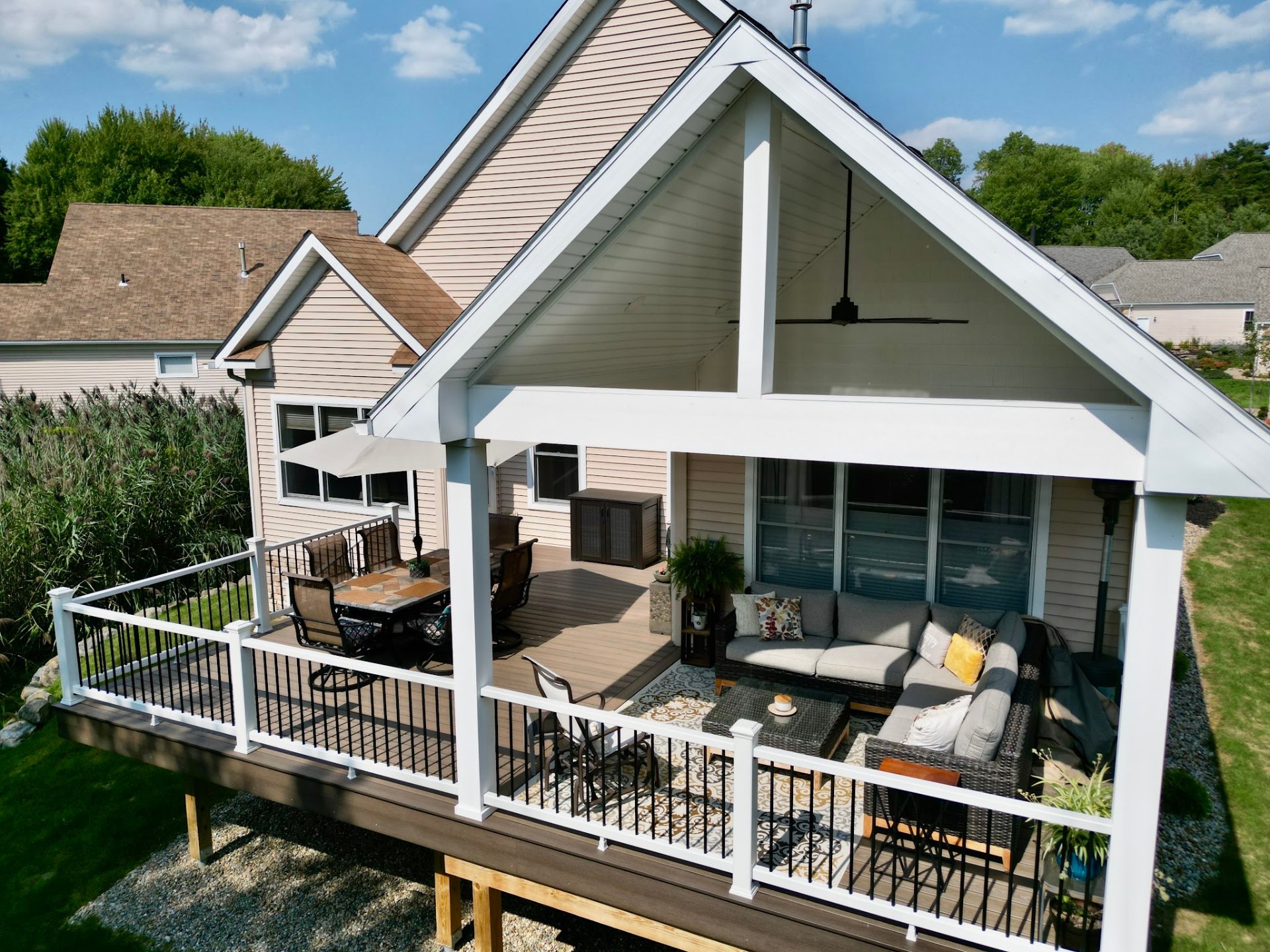Covered composite deck with outdoor furniture built by DreamDecks in Northeast Ohio