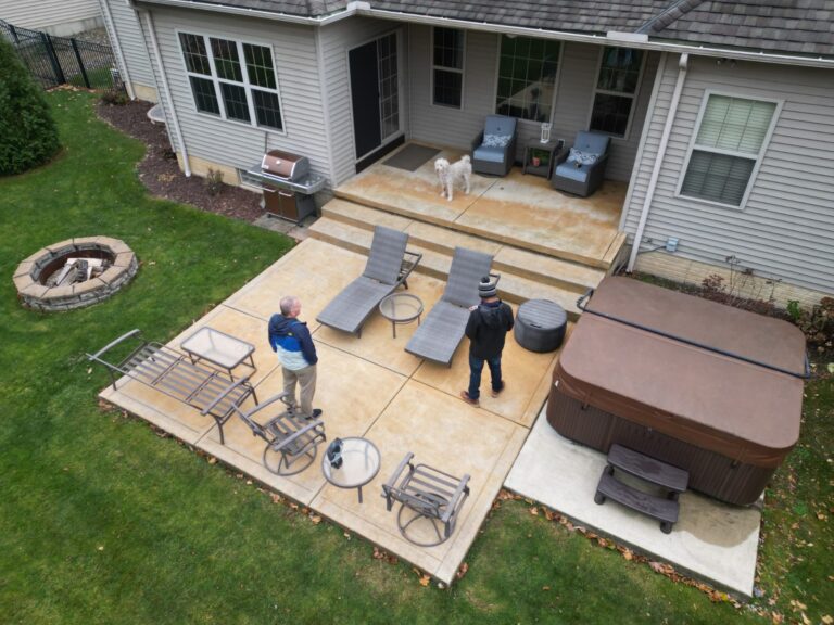 Aerial view of an old concrete patio and hot tub before DreamDecks built a composite deck over it