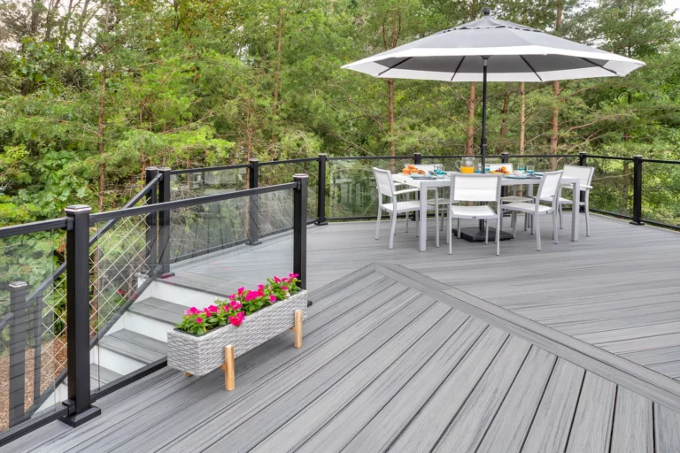 trex trex transcend island mist deck with dining area DreamDecks designs and builds architectural-grade outdoor living spaces across Northeast Ohio. From modern decks to full backyard sanctuaries, each project reflects craftsmanship, precision, and timeless luxury. Call 330-907-3040 or visit buildyourDreamDeck.com DreamDecks | Premier Deck Builder & Outdoor Architecture