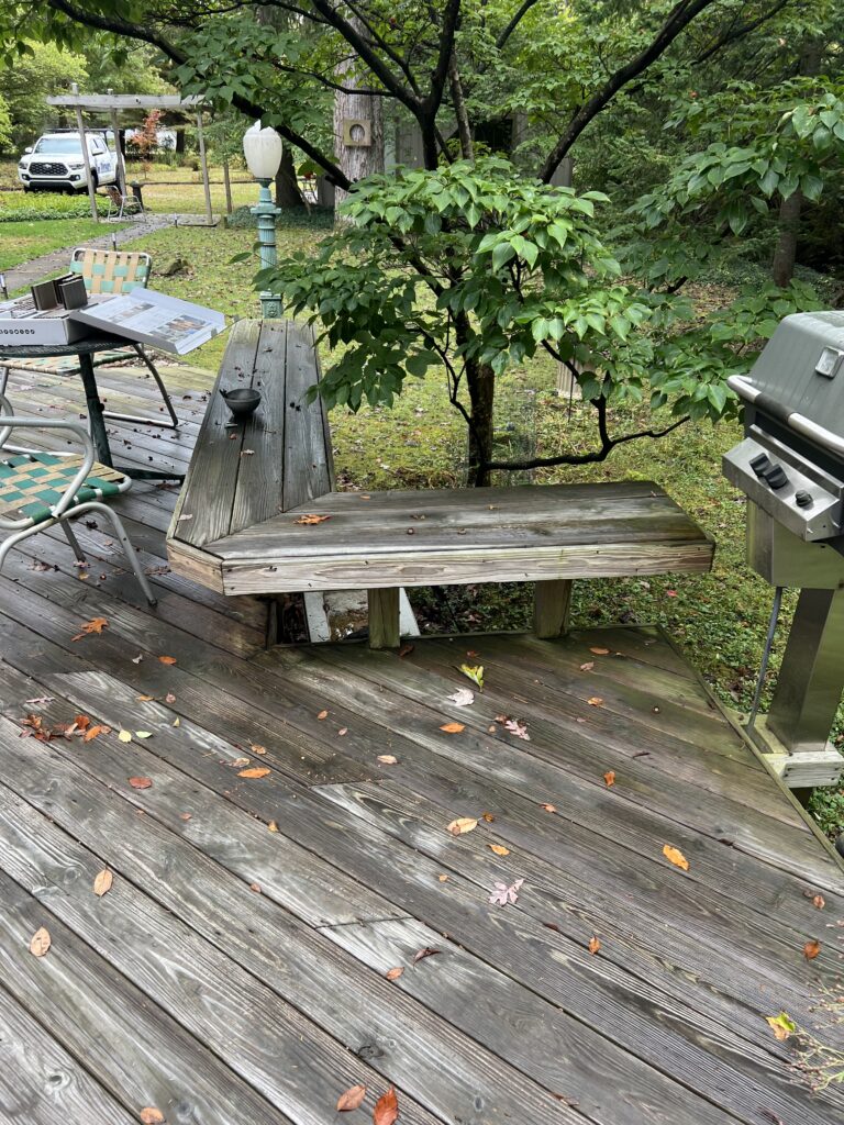 Old wood bench and decking by the grill before the resurface