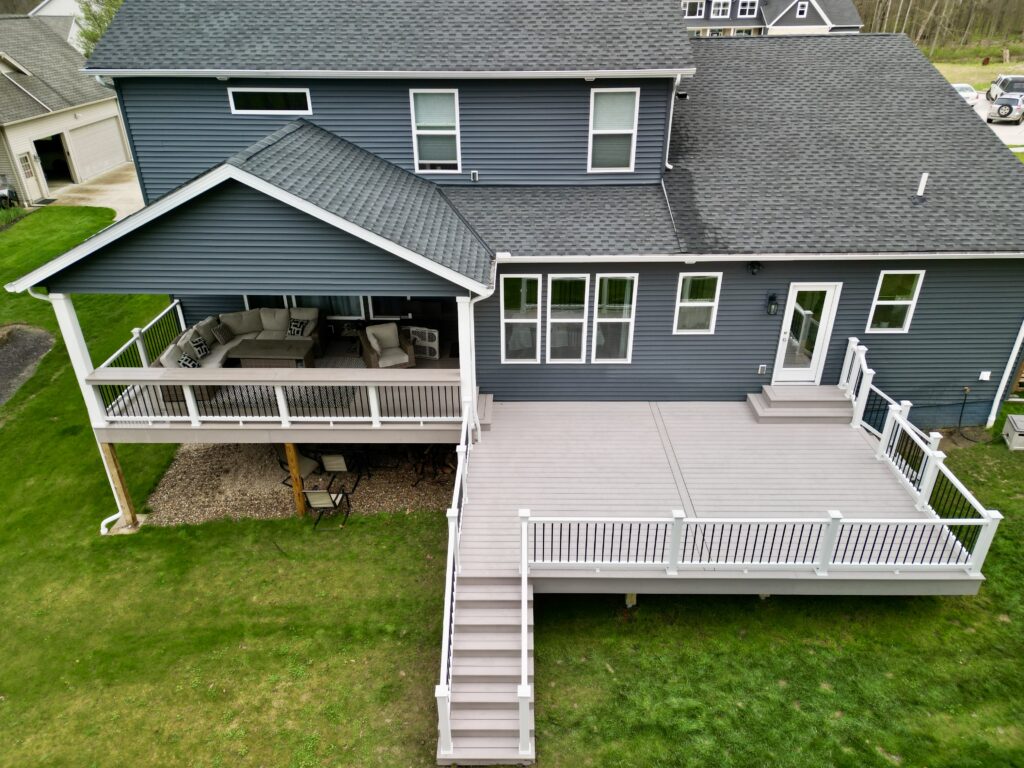 TimberTech Harvest Slate Gray lower deck with white Trex Select railing in North Royalton, Ohio