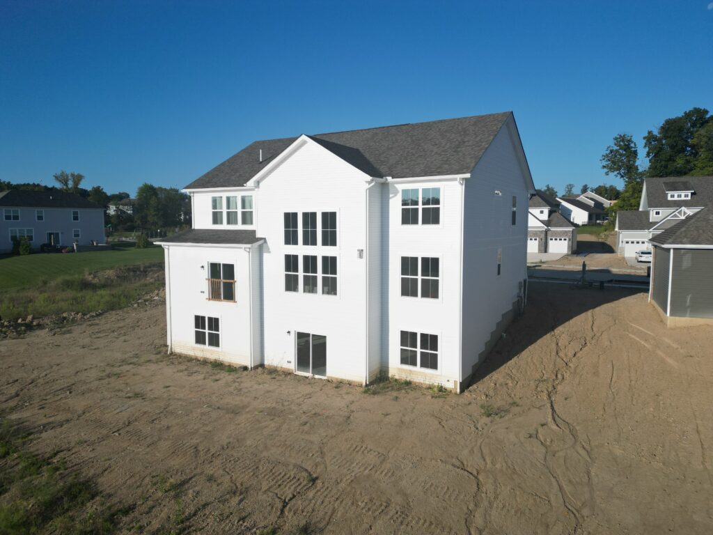 New construction home in Richfield, Ohio before DreamDecks built a two story Trex deck with a cathedral roof