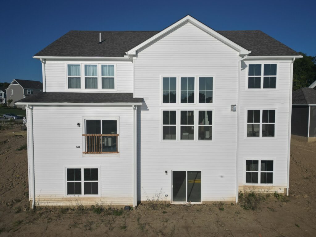 New construction home in Richfield, Ohio before DreamDecks built a two story Trex deck with a cathedral roof