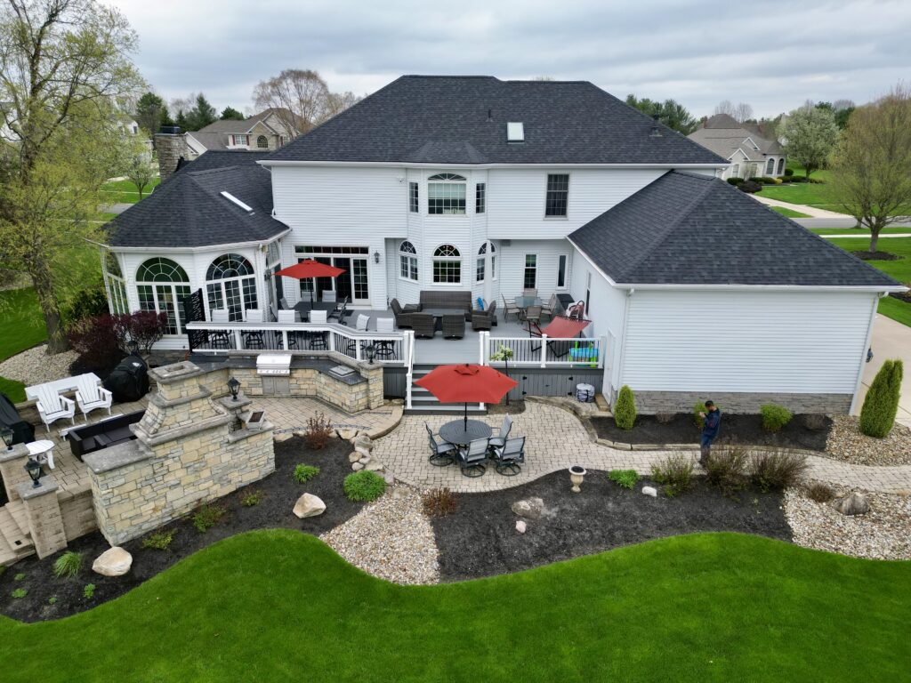 Aerial view of a Deckorators Vista Silverwood deck with a built in bar ledge and white Trex Select railing in Medina, Ohio
