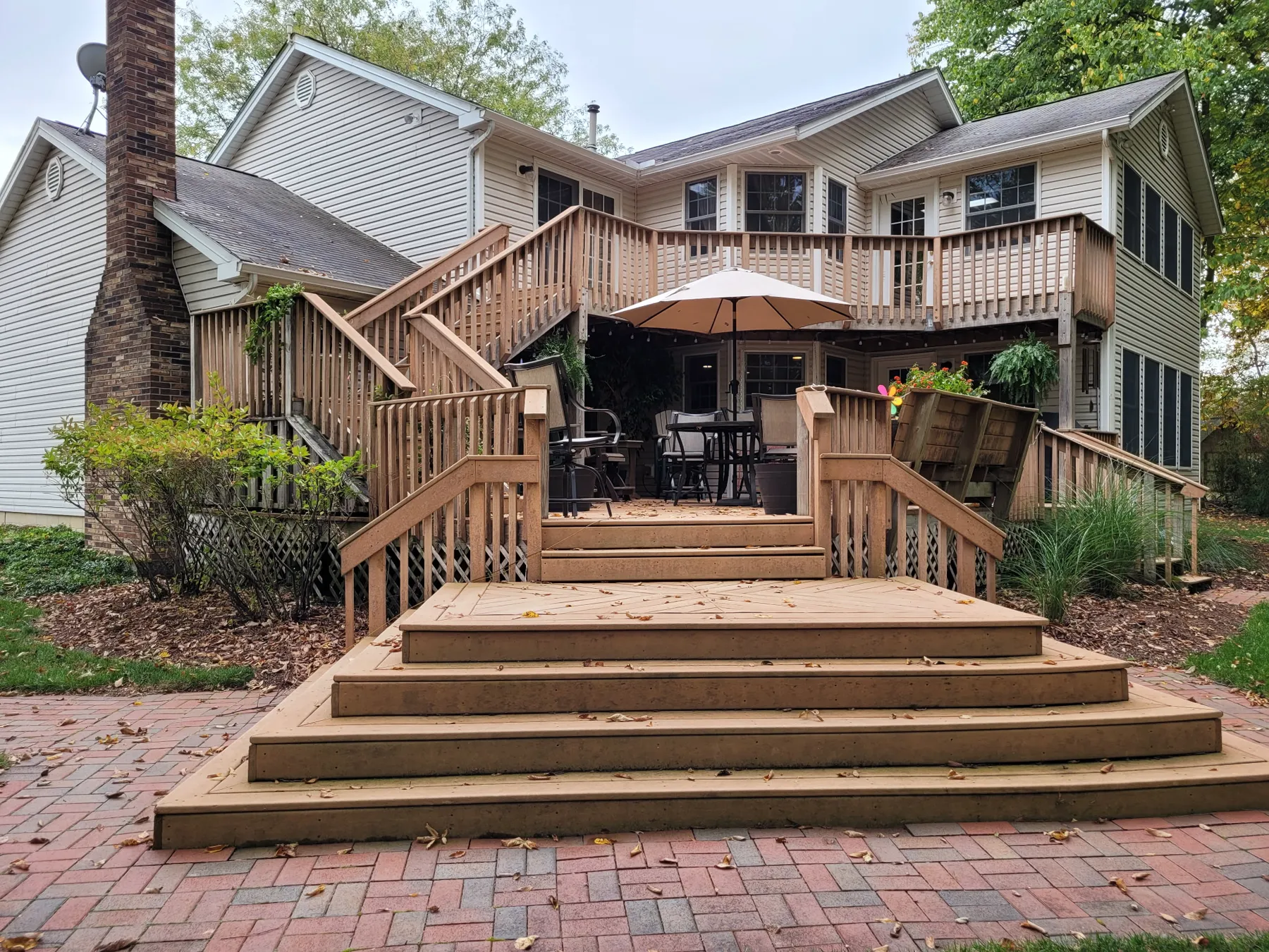 Old wood box steps leading down to the brick patio before the resurface